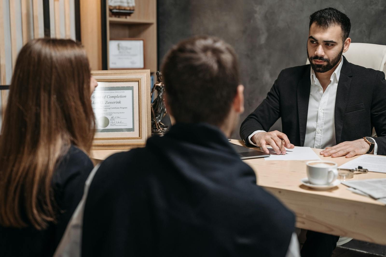 A solicitor meeting with clients at MH Solicitors